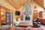 Black Bear Lodge with beautiful wood fire place and vaulted wood ceiling.